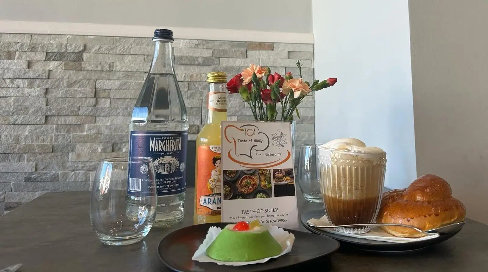 Green marzipan cassatina, a glass of coffee granita with cream and a brioche